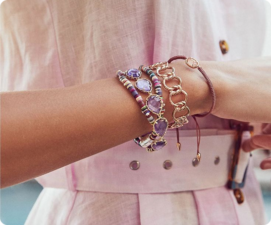 Layered necklaces on white top